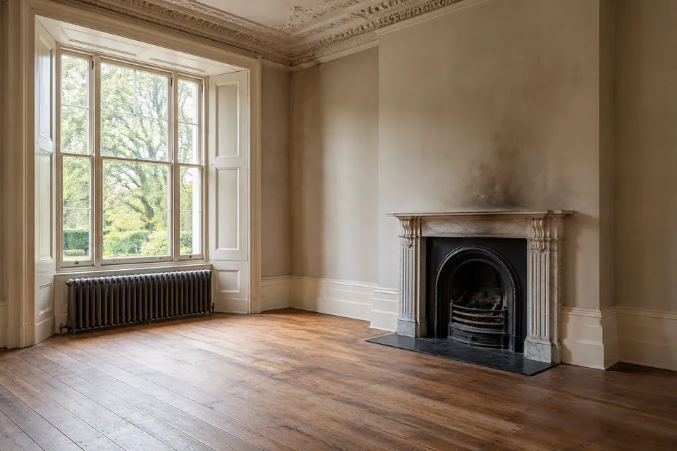 Vacant room with smoke staining above a fireplace