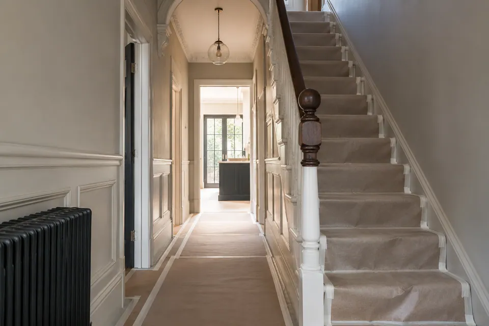 Protected hallway and timber stairs before interior work